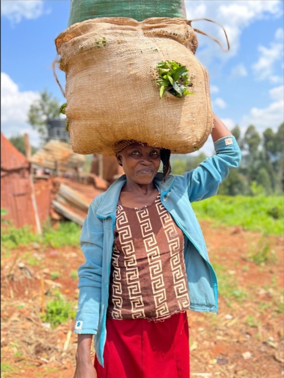 A woman carrying a harvest sack in the Smile Seekers community in Kenya